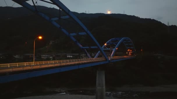 Single Car Moves Empty Arched Bridge Dark Mountain Night High — Vídeo de Stock