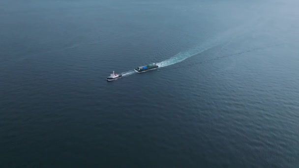 Aerial View Small Boat Towing Floating Cargo Calm Blue Sea — Stockvideo