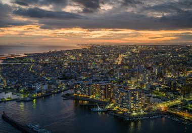 Beautiful sunset over coastal city and early evening lights. High quality photo