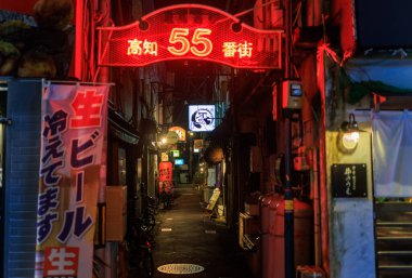 Kochi, Japan - August 10, 2022: Red neon sign at entrance to Kochi 55 Banmachi alley on quiet night. High quality photo