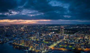 Dramatic sunset lingers in sky over downtown Akashi City at dusk. High quality photo