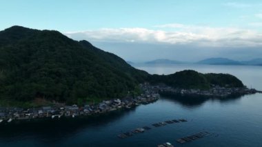 Rise over small coastal fishing village at blue hour. High quality 4k footage