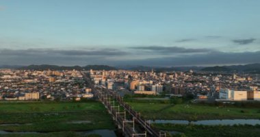 Aerial view of train tracks leading to Himeji City and castle in distance. High quality 4k footage