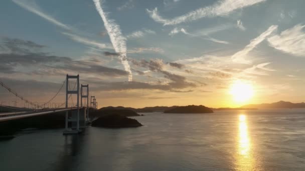 Long Suspension Bridge Many Towers Small Island Sun Sets Sea — Vídeo de Stock