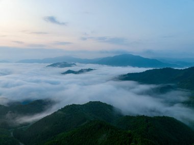 Flowing fog amid mountain peaks at dawn. High quality photo