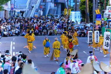 Tokushima, Japan - August 12, 2022: Performers wearing traditional yellow clothing at Awaodori street festival. High quality photo