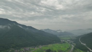 Rice fields in valley between misty mountains. High quality 4k footage