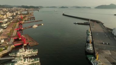 Aerial view of tugboats and fast harbor patrol ships in small harbor. High quality 4k footage