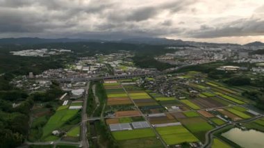 Kasabanın kıyısındaki pirinç tarlaları ve su havuzu üzerinde yavaş yavaş geri çekiliyoruz. Yüksek kalite 4k görüntü