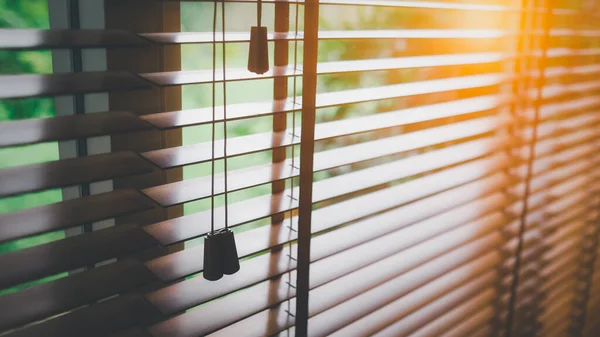 Wooden blinds with sun light.