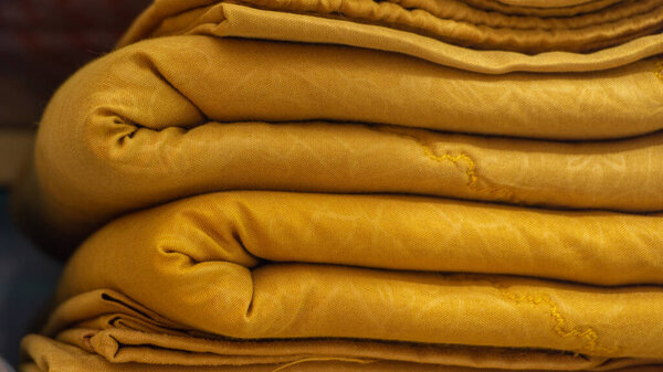 Close up  of colorful bed sheet textile. stack of clean bed sheet with different pattern