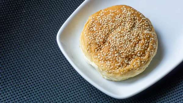 The homemade bread rolls with sesame seeds. Burger buns with sesame seeds, ingredients for hamburger.