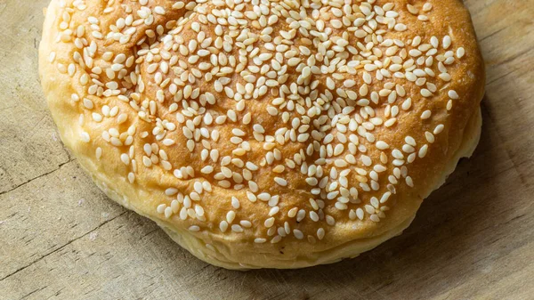 The homemade bread rolls with sesame seeds. Burger buns with sesame seeds, ingredients for hamburger.