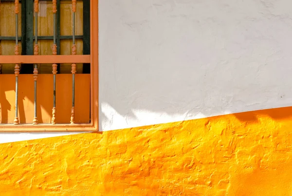 White and orange facade in the famous Candelaria, Bogota, Colombia. This minimalist picture makes a nice abstraction or  a backdrop.