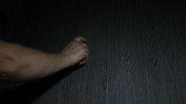 Yaşlı bir kadın parmağını ahşap bir kapıya vuruyor. Bir adam kapıyı çaldı..