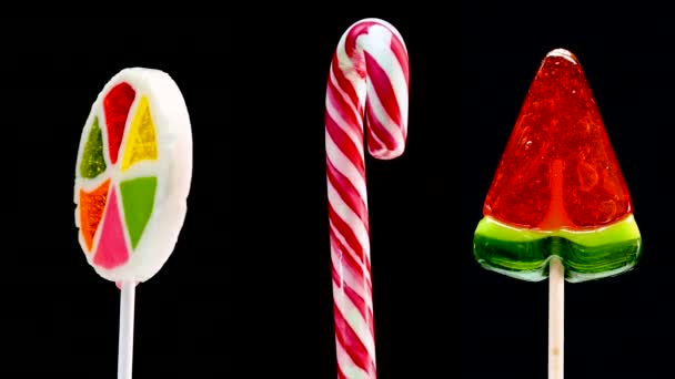 Various Lollipops Rotate Black Background Candy Cane Spiral Lollipop Caramel — Stock Video