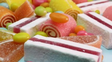 Yumuşak odaklı portakal ve limon reçeli, vanilyalı marşmelov, karışık renkli şekerler dönüyor. Çocuklar için tatlılar