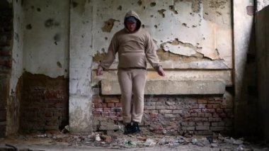 Eski bir tuğla evde ip atlayan şişman bir adam. Bir adam iple kilo kaybediyor.