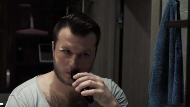 Man Shaves His Mustache Beard Trimmer Cinematic Young Man Front — Stock Video