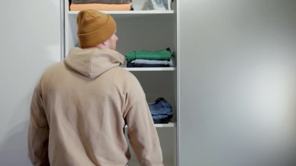 Young Guy Takes Out Green Jeans Closet Man Chooses Clothes — Video Stock