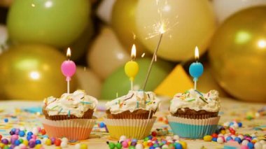 Beautiful video background happy birthday for any age, cream cupcake with festive candles and sparklers. Birthday greetings