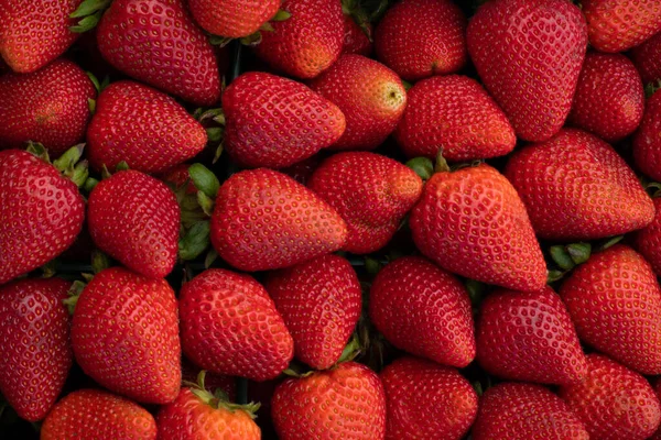 Fresh red strawberries on the farmers market stand closeup pattern for backdrop
