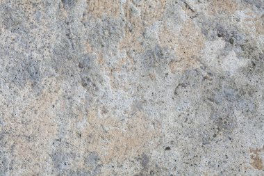 Closeup full frame of the rough textured multi colored concrete wall surface for backdrop