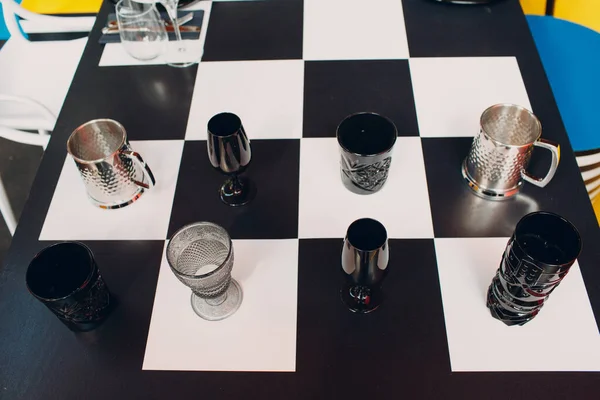 Wedding table decor like a chessboard with black and white dishes glasses — Stock Photo, Image