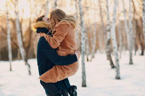 Loving young couple walking playing and having fun in winter forest park — Stock Photo, Image