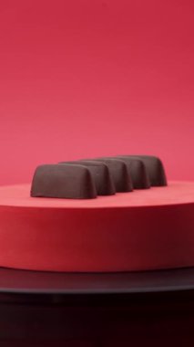 Yakın plan: Kırmızı zemin üzerinde çikolata ve şeker kompozisyonu