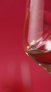 Yakın plan: kırmızı şarap bardağa dökülür.