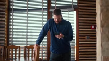 Businessman checking bitcoin price chart on digital exchange on mobile phone screen, cryptocurrency future price prediction concept