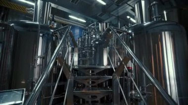 Large steel tanks with beer in industrial brewery plant. Stainless steel tanks for brewing beer. automated process. Modern Beer Factory.
