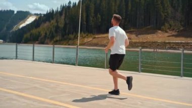 Young man running fast intense workout challenge endurance training in forest