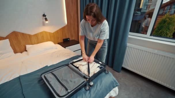 Young Girl Takes Out Her Clothes Suitcase — Wideo stockowe