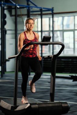 Koşu bandında koşan bayan sporcu