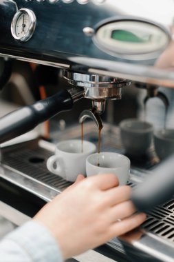 Making coffee espresso or ristretto in coffee machine. Home making hot Espresso. Coffee with froth. Espresso in a white cup. Tasty coffee. Caffeine.