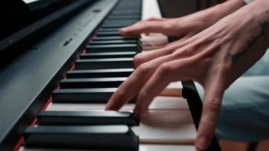 Close-up: a woman sensually plays the piano