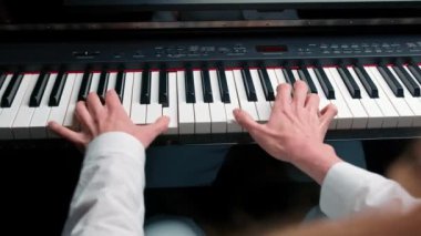 Close-up: a woman sensually plays the piano