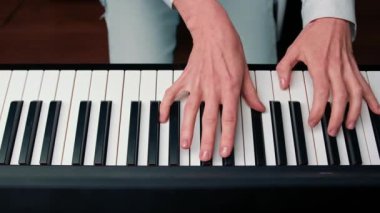 Close-up: a woman sensually plays the piano
