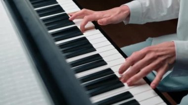 Close-up: a woman sensually plays the piano