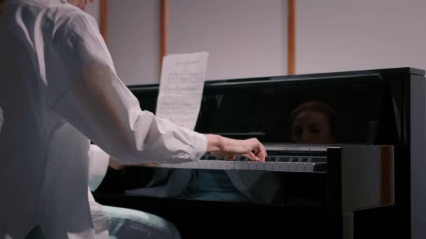 Woman Sensually Playing Piano View Back — Stok Video