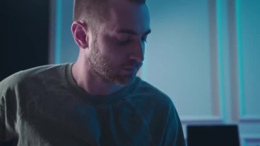 Man plays guitar in professional music studio. Man plays a musical instrument. Musician records his composition in a music Studio.