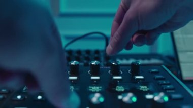 Music production studio. Music composer, sound engineer. A man works with equipment for processing and mixing sound. Music track.