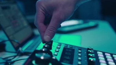 Music production studio. Music composer, sound engineer. A man works with equipment for processing and mixing sound. Music track.