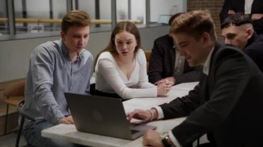A team of specialists is actively discussing a new product. They are unhappy and debate. Designers and financiers.