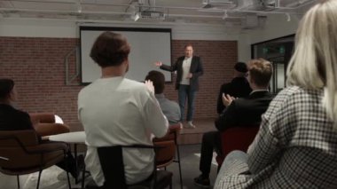 Businessman company representative present to investors new strategy, business coach teaching trainees during lecture seminar