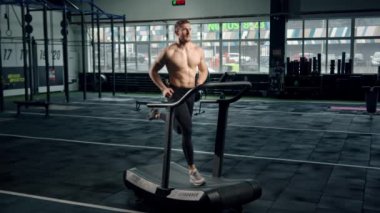 Male athlete athlete is doing cardio training on a treadmill, bodybuilder