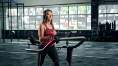 Woman athlete athlete is engaged in cardio training on the treadmill, thin sports girl