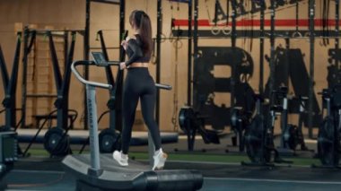 Woman athlete athlete is engaged in cardio training on the treadmill, thin sports girl